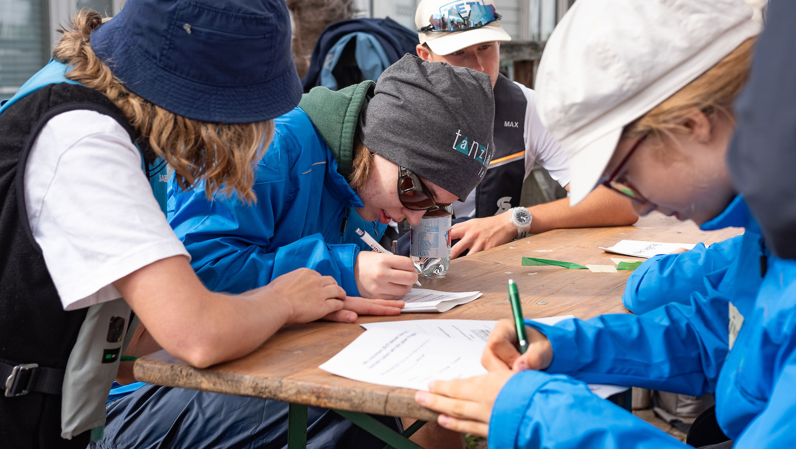 Young people are filling in questionnaires.